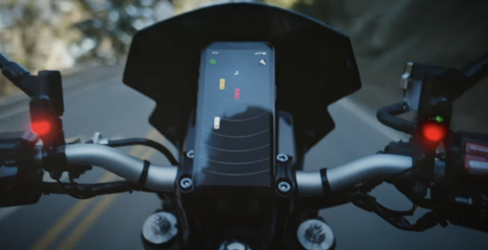 The Garmin Zumo R1 showing a vehicle in the rider's blindspot displayed on a Smartphone